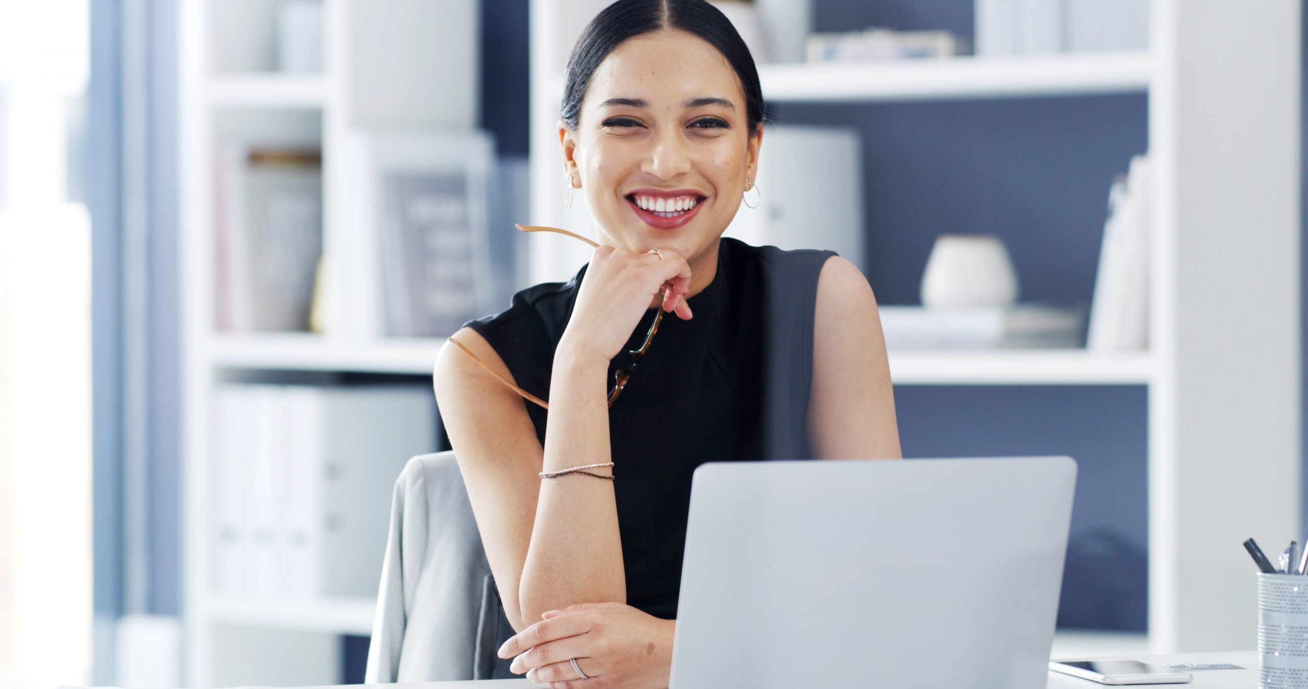 woman smiling in front of a computer